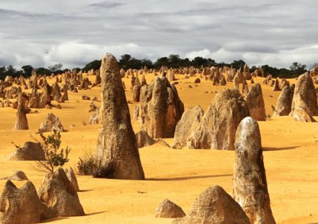 Thousands of limestone spires rise from the stark yellow landscape of the Pinnacles Desert near the western coastal town of Cervantes, Australia. (Photo by Tobias Keller)